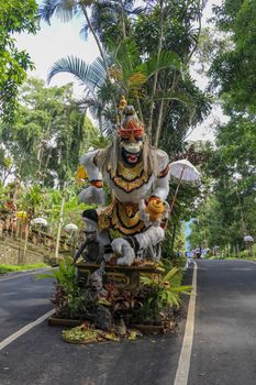 Statue of Hanuman, Hindu god and divine monkey - vanara companion of the god Rama, holding gada - mace. Bali, Indonesia. Colorful Beautiful Statue Of Indian Lord God Idol Sankatmochan Jai Hanuman.