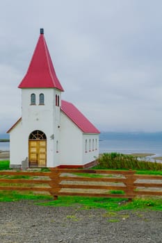 Countryside and a secluded church along the Hrutafjordur fjord, in the west fjords region, Iceland