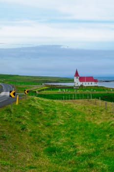 Countryside and a secluded church along the Hrutafjordur fjord, in the west fjords region, Iceland