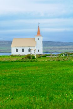 Countryside and a secluded church along the Kollafjordur fjord, in the west fjords region, Iceland