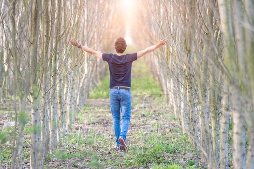 young man on a walk through nature, balanced thoughts and relaxation.