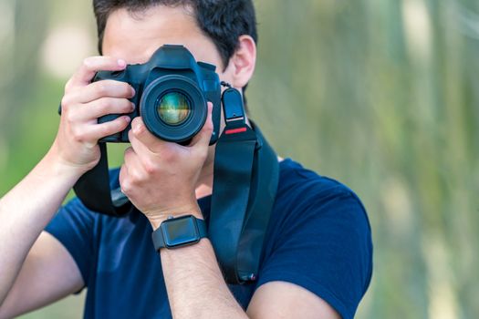 young man photographer in nature