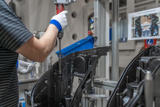 assembly of plastic molds on the production line in the factory.