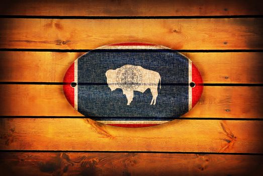 Wyoming flag on brown wooden planks.