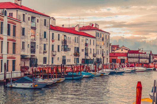 Houses with a red tile roof on the seashore in Venice, Italy