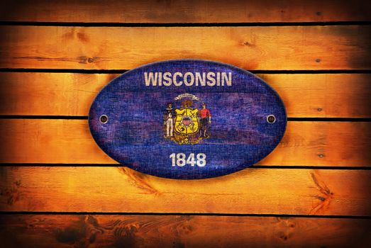 Wisconsin flag on brown wooden planks.