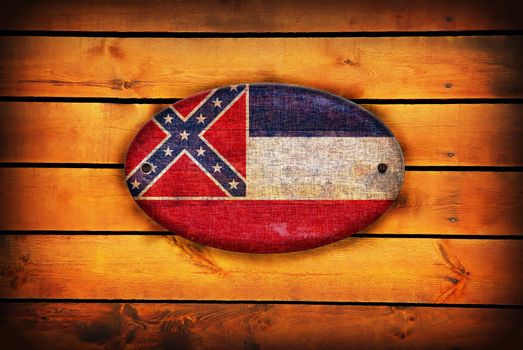 A Mississippi flag on brown wooden planks.