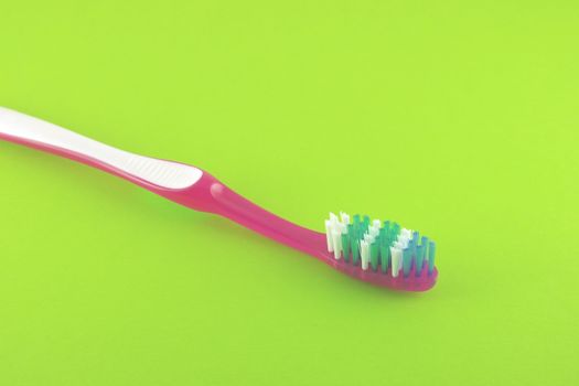 Tooth-brush over bright green