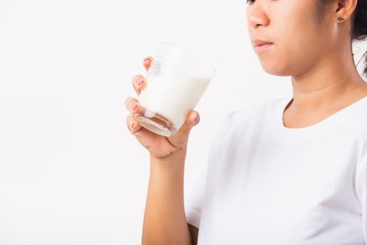 Asian portrait of happy young Asian beauty woman use hands hold drink white milk from a glass, studio shot isolated on white background, Food healthy care concept