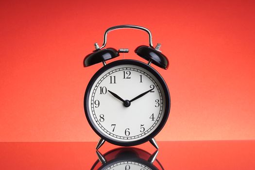 Alarm Clock on red background with selective focus and crop fragment. Business and Copy space concept