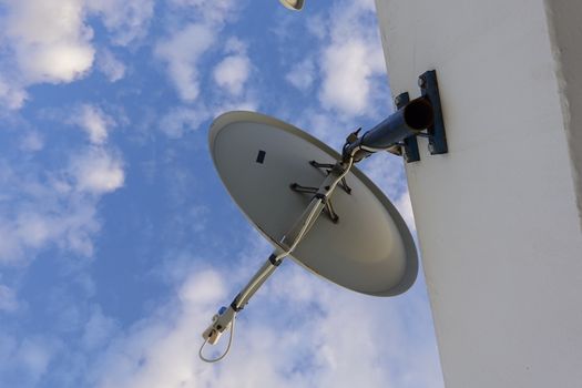 a satellite dish pointing to the blue sky.