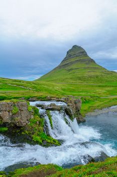 View of the Kirkjufell mountain (Church mountain), and the Kirkjufellsfoss waterfalls, in the Snaefellsnes peninsula, west Iceland