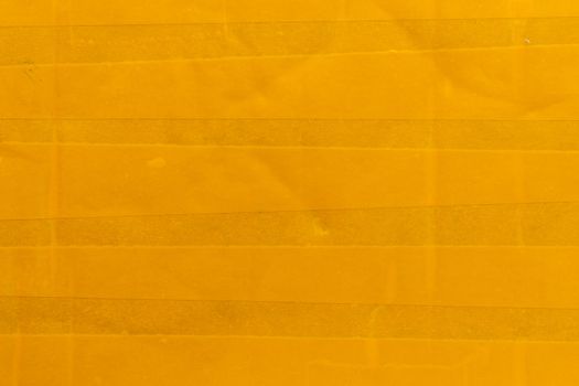 yellow sticky tape wrapped flat surface texture and close-up background.