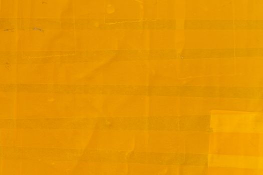 yellow sticky tape wrapped flat surface texture and close-up background.