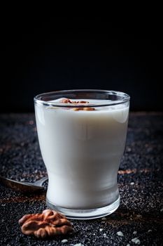 Layered greek yogurt parfait with strawberry and nut in a glass.