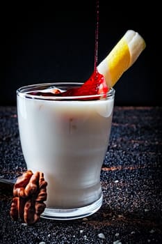 Layered greek yogurt parfait with strawberry and nut in a glass.