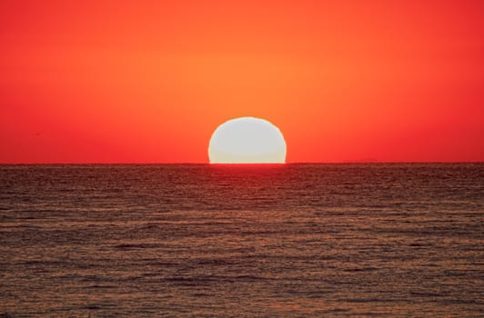 big sun down over sea, red sky