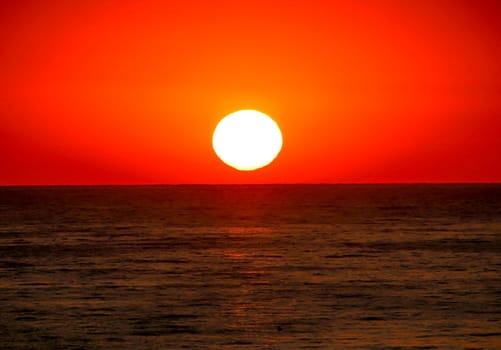 big sun down over sea, red sky