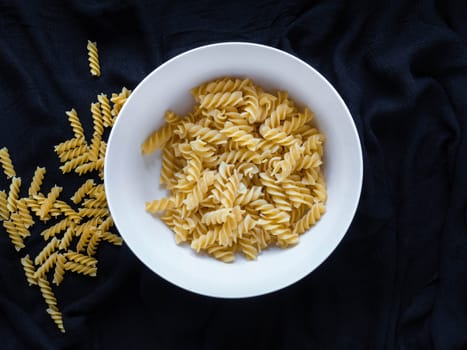 Fusilli and Black fabric background
Use as wallpaper