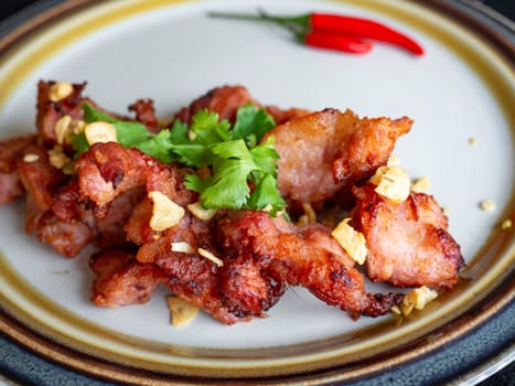 Fried Pork with Garlic Thai food
Ingredients of pork ribs,Decorate the dish with red chilies, garlic and coriander on a white plate.