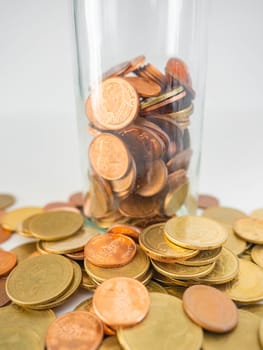 Thai Baht Coins colors Gold set in the mountains,Is the currency of Thailand.For business expenses,Coin is in a jar of money saving,White background