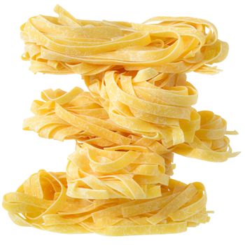 Fettuccine pasta nests close up on a isolated white background.