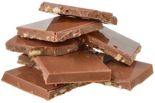 Heap cubes of chocolate with nuts close up isolated on white background.