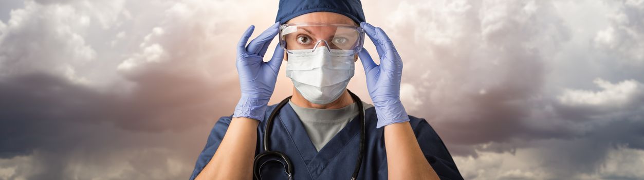 Doctor or Nurse Adjusting Safety Goggles Wearing Personal Protective Equipment Over Ominous Clouds.
