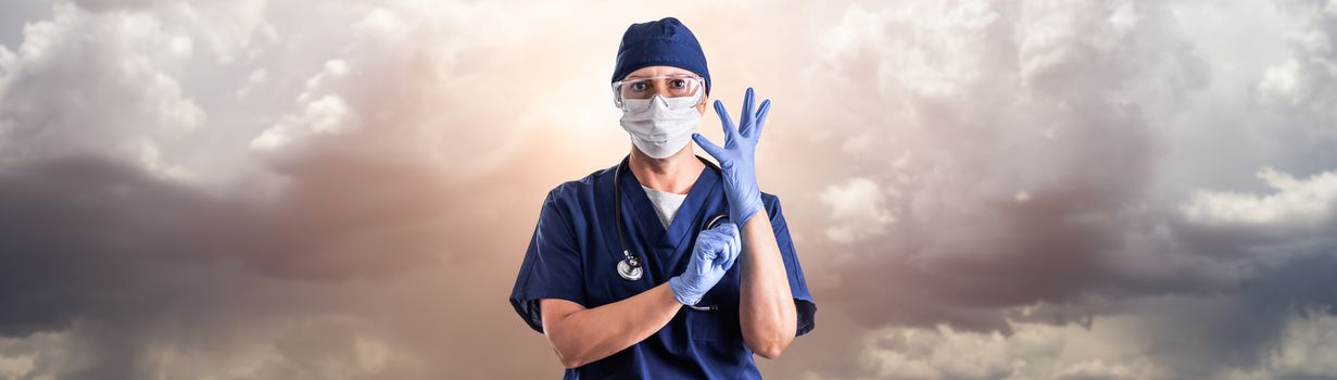 Doctor or Nurse Adjusting Surgical Gloves Wearing Personal Protective Equipment Over Ominous Clouds.