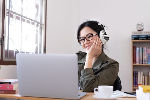 Modern young Asian woman working from home with happy, smile, and relax..