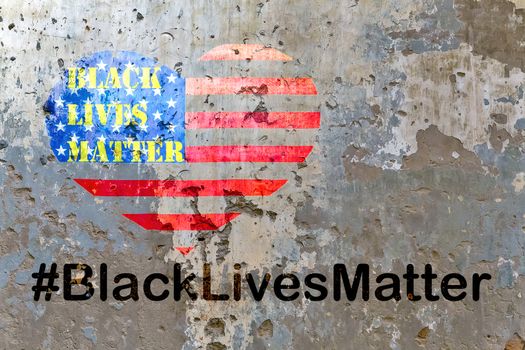 Black Lives Matter slogan hashtag liberation banner protestors heart stencil on American flag USA city street of a old concrete wall