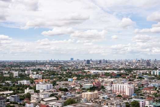 The Bangkok cityscape from skyscraper view with clouds and blue sky.