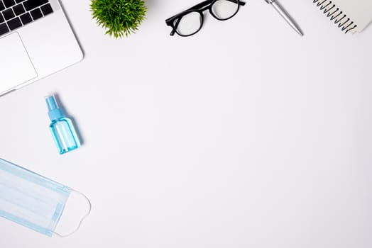 The equipment to protect COVID-19, blue mask and hand cleaner gel for preparing to work from home Isolated on white background concept.