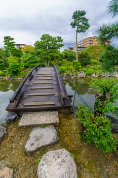 View of a wooden bridge in the Shosei-en Garden (Kikoku-tei), in Kyoto, Japan