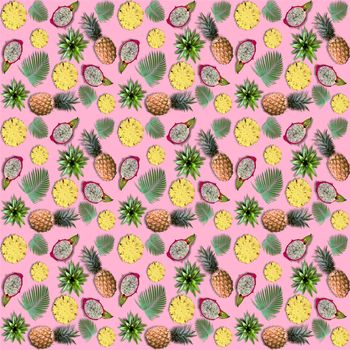 Exotic fruits and tropical palm leaves on pink background. Summer fruits pattern of pineapple, dragon fruit and palm leaves. 