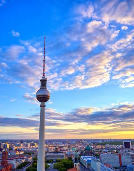 A view of the television tower (Fernsehturm) over the city of Berlin, Germany at sunset.