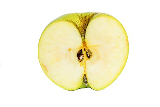 Fresh green apples cut in half on a white background