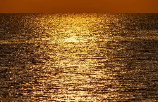 Early morning, dramatic gold sunrise over sea