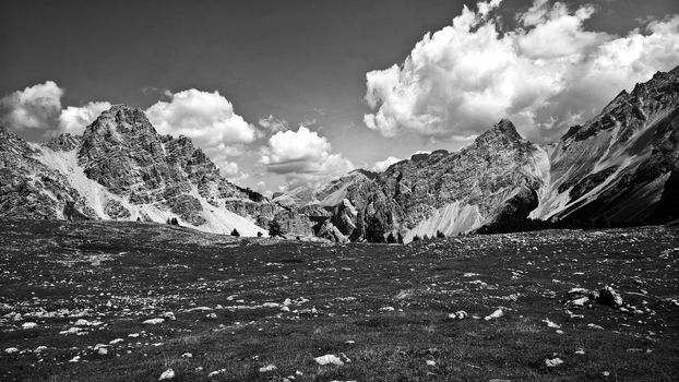 Trentino Alto - Adige, Italy - 06/15/2020: cenic alpine place with magical Dolomites mountains in background, amazing clouds and blue sky in Trentino Alto Adige region, Italy, Europe