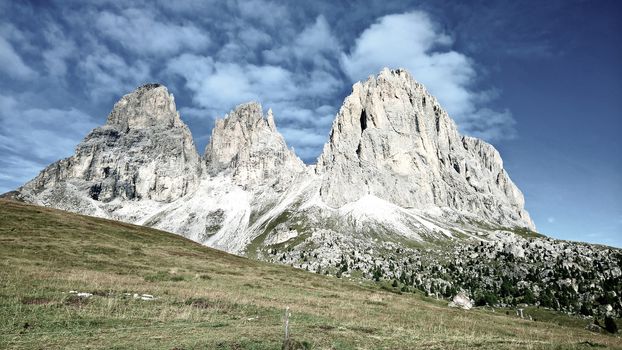 Trentino Alto - Adige, Italy - 06/15/2020: cenic alpine place with magical Dolomites mountains in background, amazing clouds and blue sky in Trentino Alto Adige region, Italy, Europe