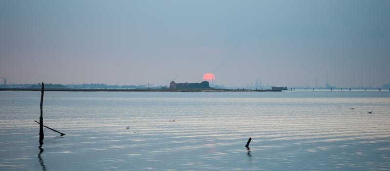 Sunset and Venice skyline, in Burano, Venice, Veneto, Italy