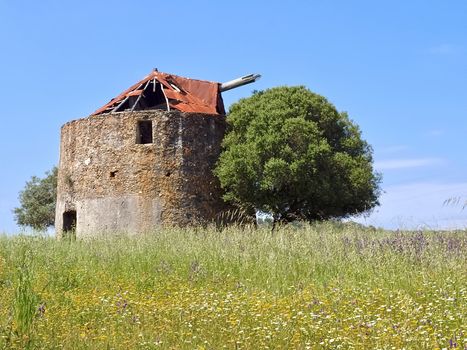Beautiful alentejo in Portugal with an old windmill and a red roof near Odeceixe
