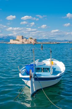 A boat and an old fortress island, in Nafplio, Peloponnese, Greece