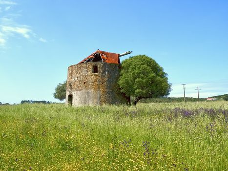 Beautiful Alentejo in Portugal with an old windmill and a red roof near Odeceixe