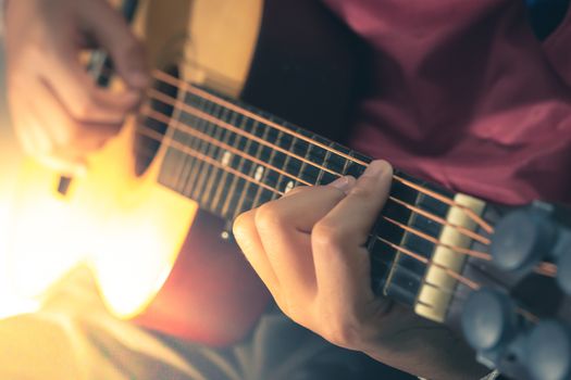 Man playing an acoustic guitar detail blur art