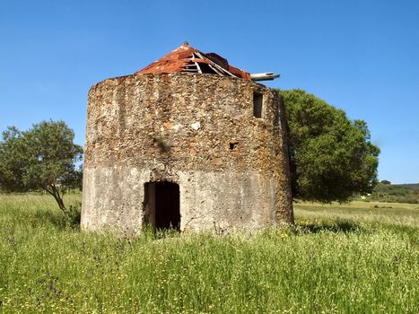 Beautiful Alentejo in Portugal with an old windmill and a red roof near Odeceixe