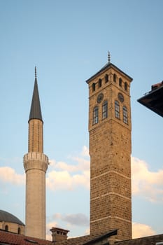 The minaret of the Ferhadija Mosque, and a clock tower, in Sarajevo, Bosnia and Herzegovina