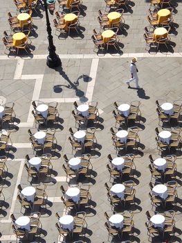 Aerial view of empty gastronomy chairs and tables in Venice
