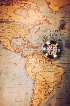 Old vintage retro golden compass on ancient map. Selective focus, shallow depth of field. Concept of world travel, sightseeing and tourism.