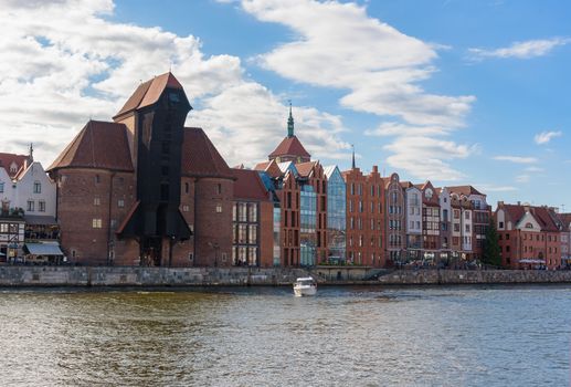 Riverside promenade in the old town of Gdansk with famous medieval port crane
